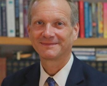 Greg Newby in a suit and tie