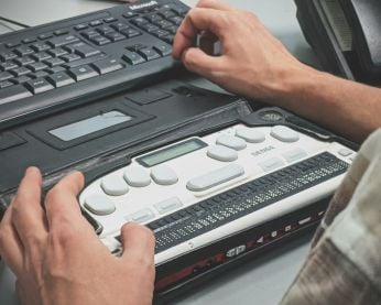 Person using a braille screen reader.