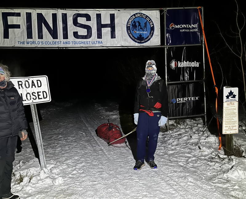 Greg at the finish line of the Montane Yukon Ultra 100-mile race.