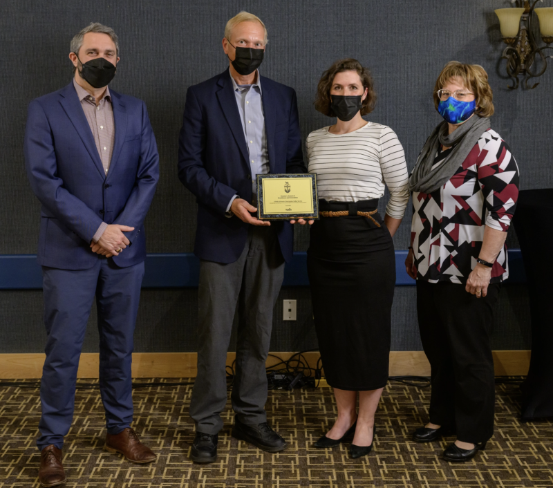 Premier Sandy Silver presents award to Covid 19 Proof of Vaccination team in 2022.