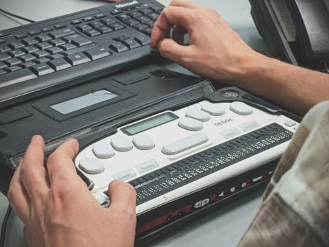 Person using a braille screen reader.