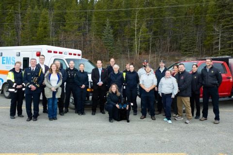 Dr. Tim Black, National Clinical Director, Wounded Warriors Canada, Minister of Community Services Cory Bellmore,  Minister of Health and Social Services Brad Cathers , Wendy Hafemeister Director of Wildland Fire Management, Greg Blackjack Director of Emergency Measures Organization and Devin Bailey Chief of Emergency Medical Services, pose alongside members of the Emergency Services units. The announcement of the the expansion of the partnership between the Government of Yukon and Wounded Warriors Canada t