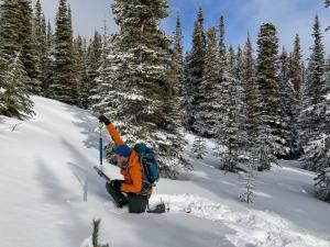 Water Resources' Alex Mischler weighs a snow sample at Mount McIntyre snow course in the Whitehorse area.