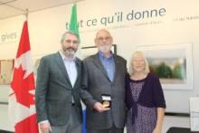 Premier Silver presents the Council of the Federation Literacy Award to Donald Inverarity.