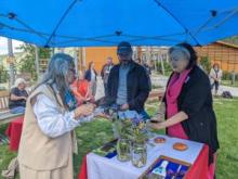 Tr’ondëk Hwëch’in Hähkè Darren Taylor and Minister of Health and Social Services Tracy-Anne McPhee participate in a signing ceremony with Elder Clara VanBibber. The Memorandum of Understanding was signed in Dawson City on June 13.