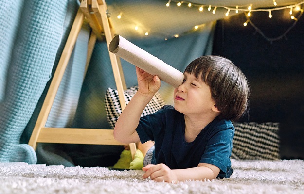 Boy playing by indoor tent