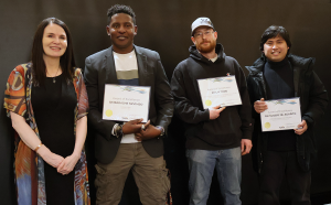 Minister Jeanie McLean congratulates carpenter Simbarashe Nzvimbo, heavy equipment and truck and transport technician Philip Todd, and construction electrician Reynaldo Jr. Agapito on receiving awards of excellence. Photo credit: YG