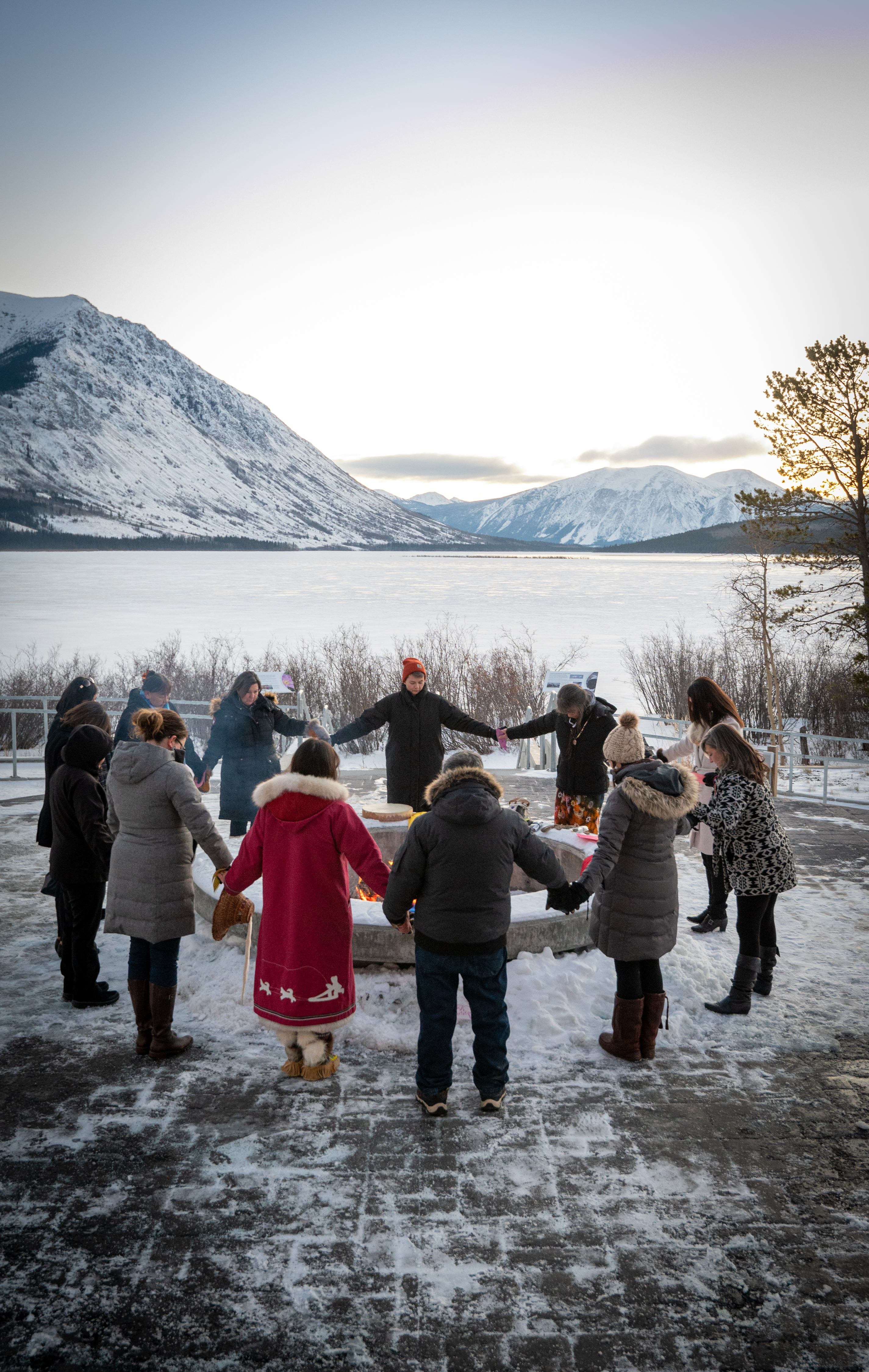 Attendees gather around the sacred fire at the announcement of Priority Action Items for the Yukon\u2019s MMIWG2S+ Strategy in December 2022.
