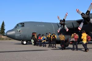 Wildland firefighters board a 435 Squadron Royal Canadian Air Force CC-130 Hercules to join the British Columbia wildfire response on Monday, August 16, 2021. Photo credit: Government of Yukon