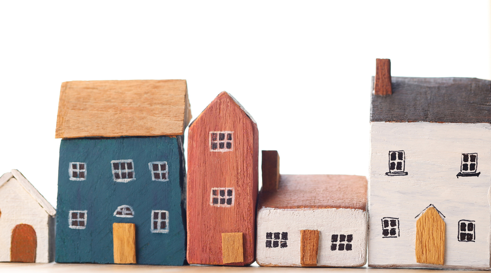 A row of toy blocks in various shapes and sizes painted to look like houses. Text reads rental housing 101.