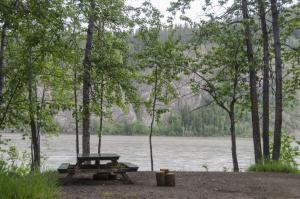 Photo of riverside campsite with picnic table at Yukon River Campground.