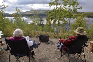 Relaxing in a campsite overlooking the water at Twin Lakes Campground, Yukon.