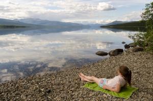 Child on gravel beach at Quiet Lake South Campground, Yukon