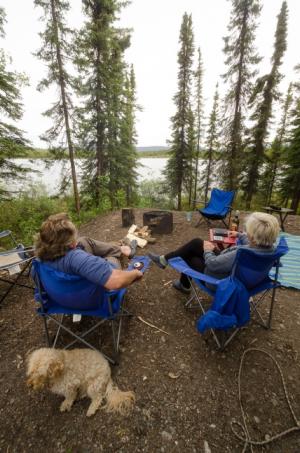 Relaxing in a campsite overlooking the water at Snag Junction Campground, Yukon.