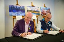 Yukon Minister of Environment Nils Clarke and Northwest Territories Minister of the Department of Environment and Natural Resources Shane Thompson sign two Bilateral Water Management Agreements