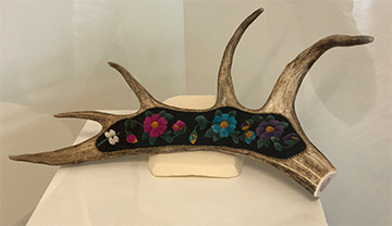Antler decorated with felt flowers and beads.