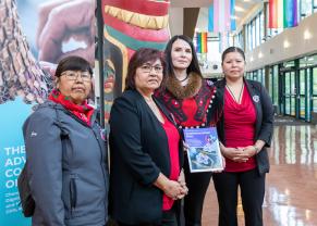 Members of the Yukon Advisory Committee on MMIWG2S+ pose with the Implementation Plan after the public launch of the document on June 6, 2023 at Yukon Arts Centre. 